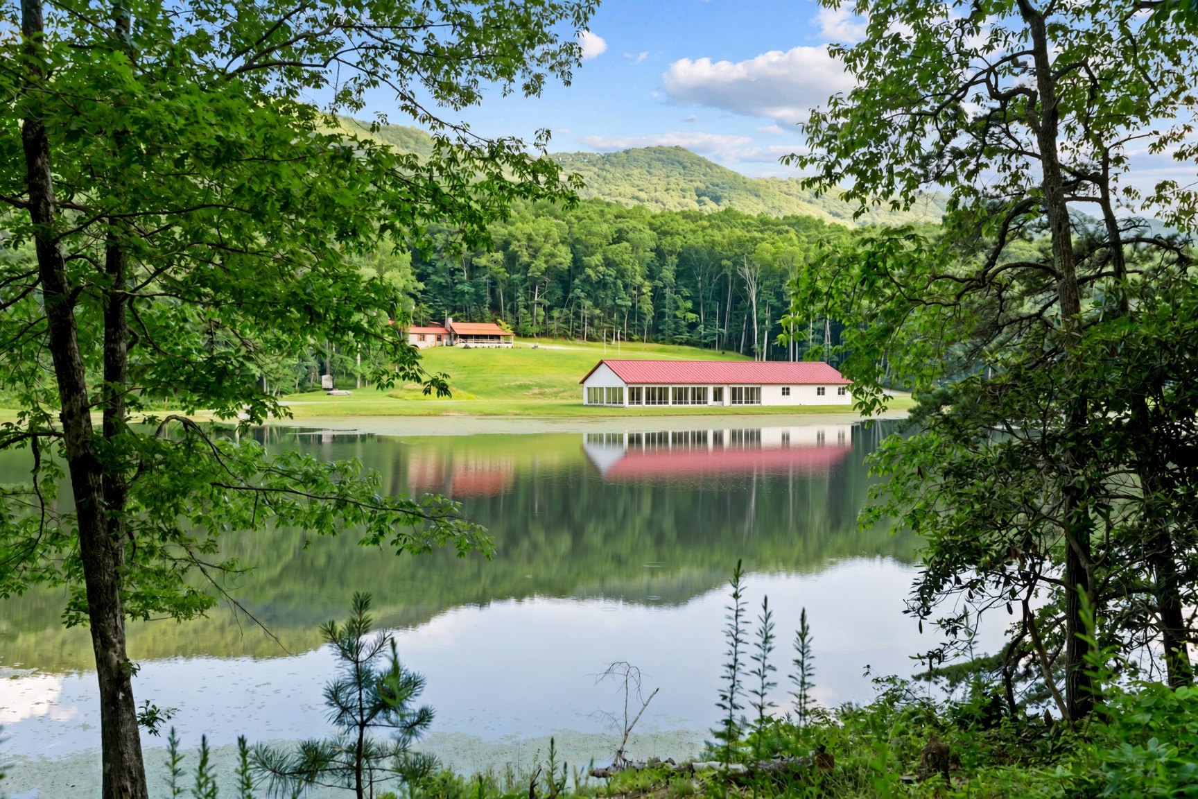 Campus view across the lake, with a rendering of Lake Hall below the lodge