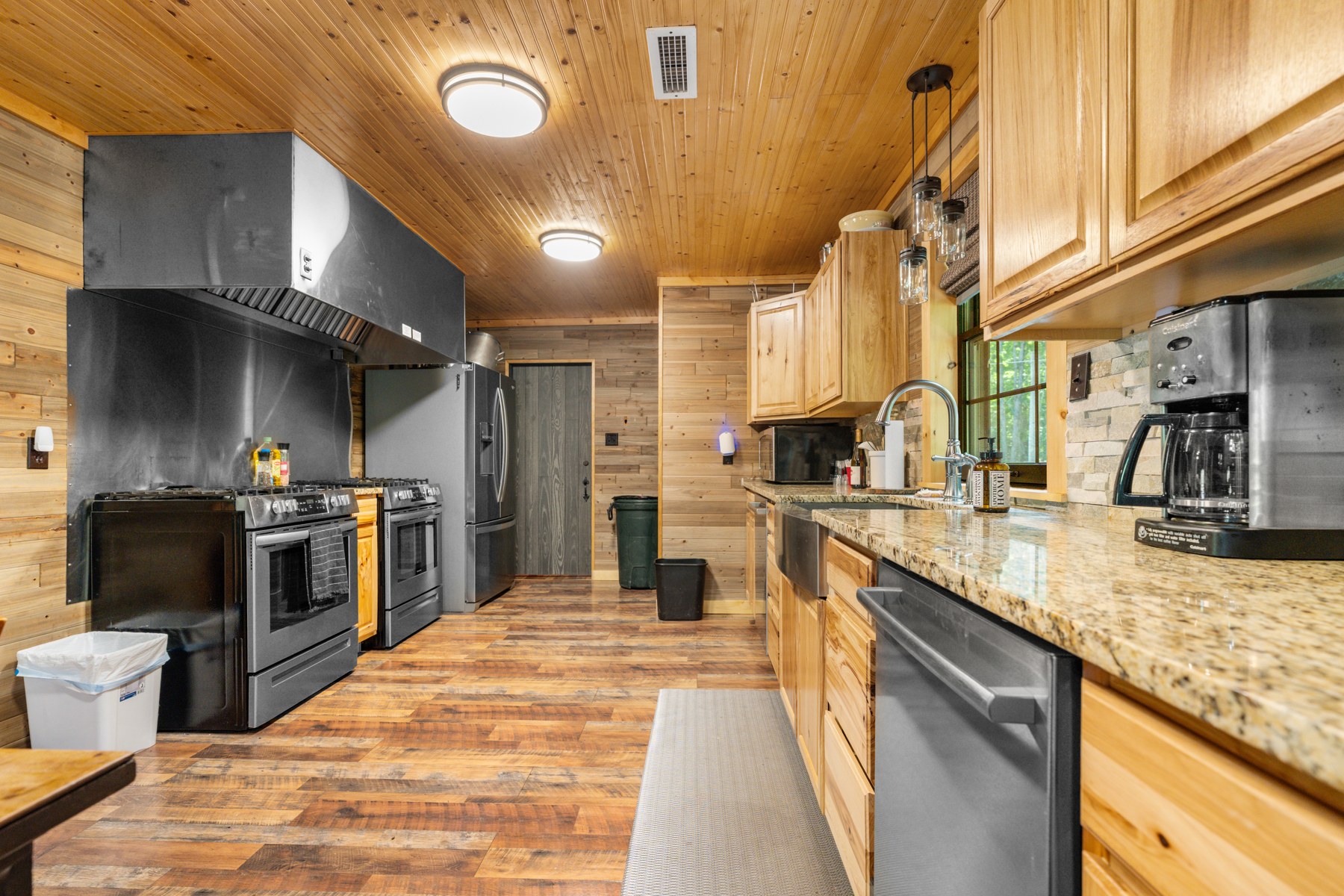 Lodge kitchen with wood cabinets, a range, and refrigerator